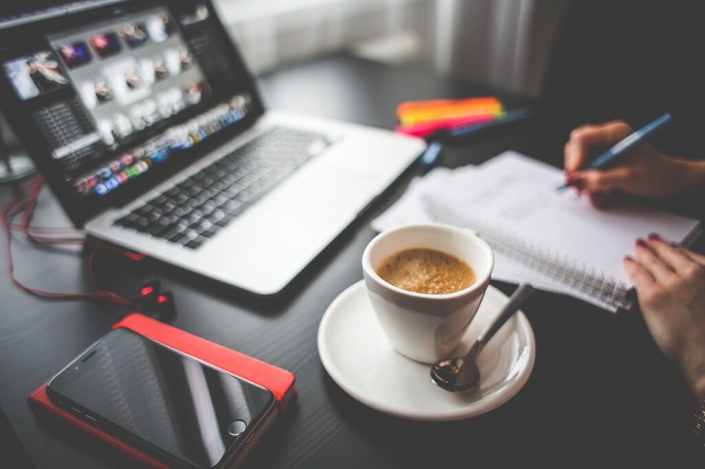 computer, coffee cup and notepad